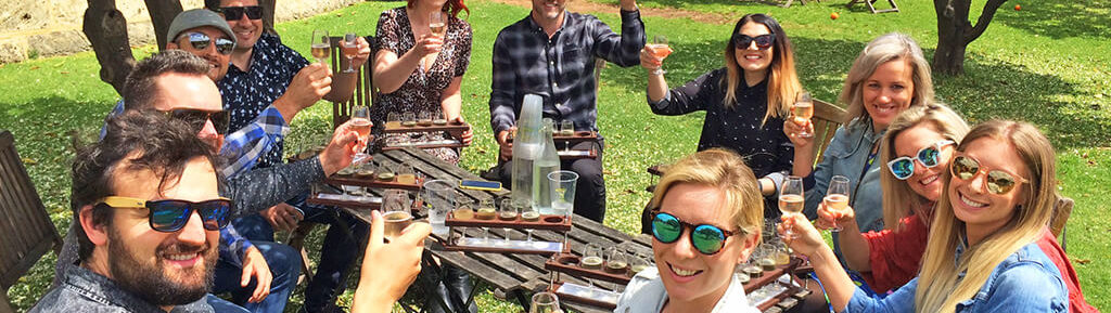 Group of People Drinking Beer Around A Table Outside